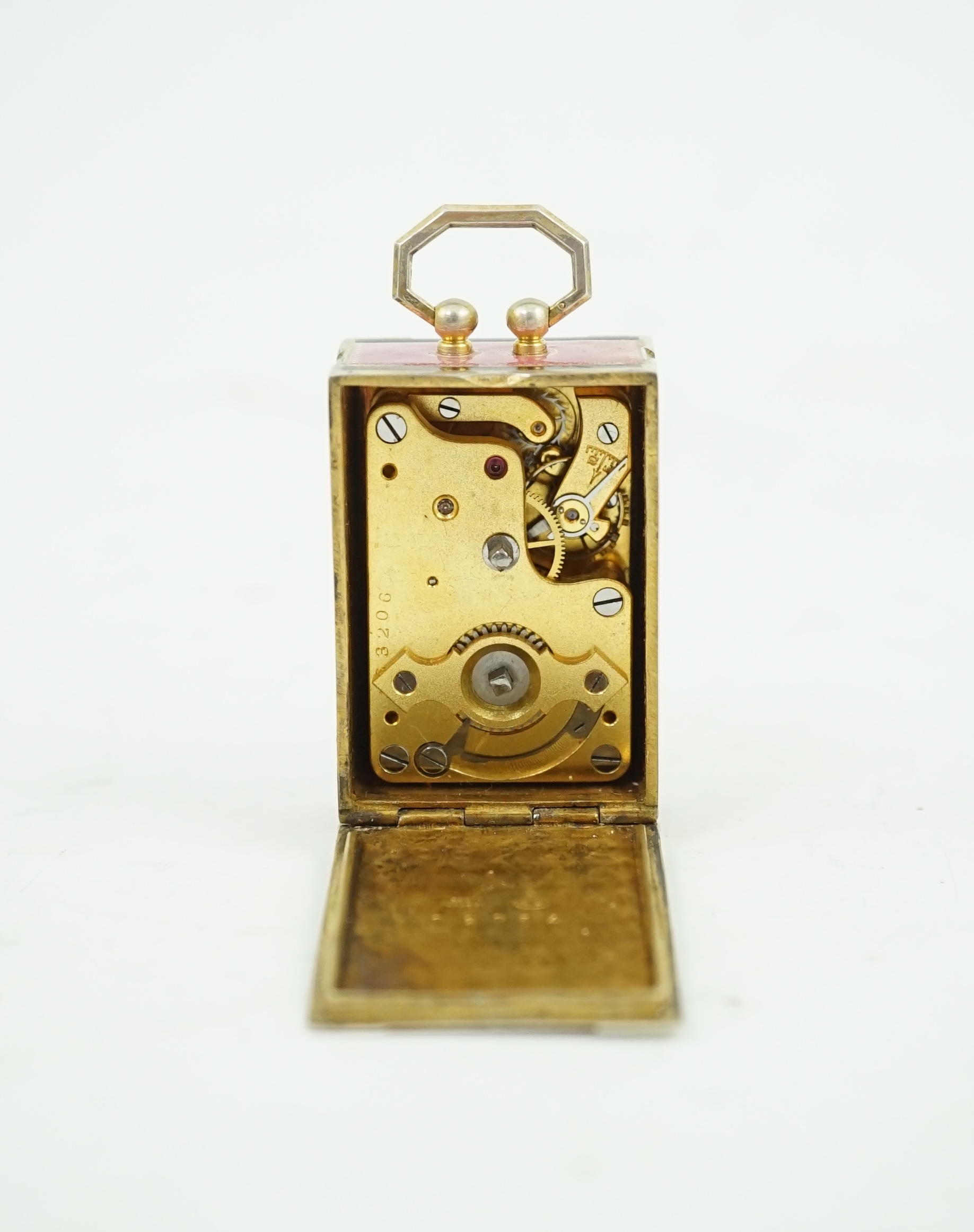 An early 20th century Swiss silver gilt and two colour enamel miniature carriage timepiece